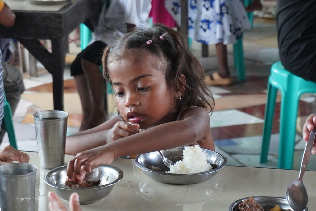 One girls enjoys her meal.