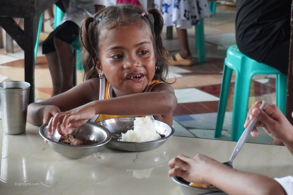 Aeta girl enjoys her meal.