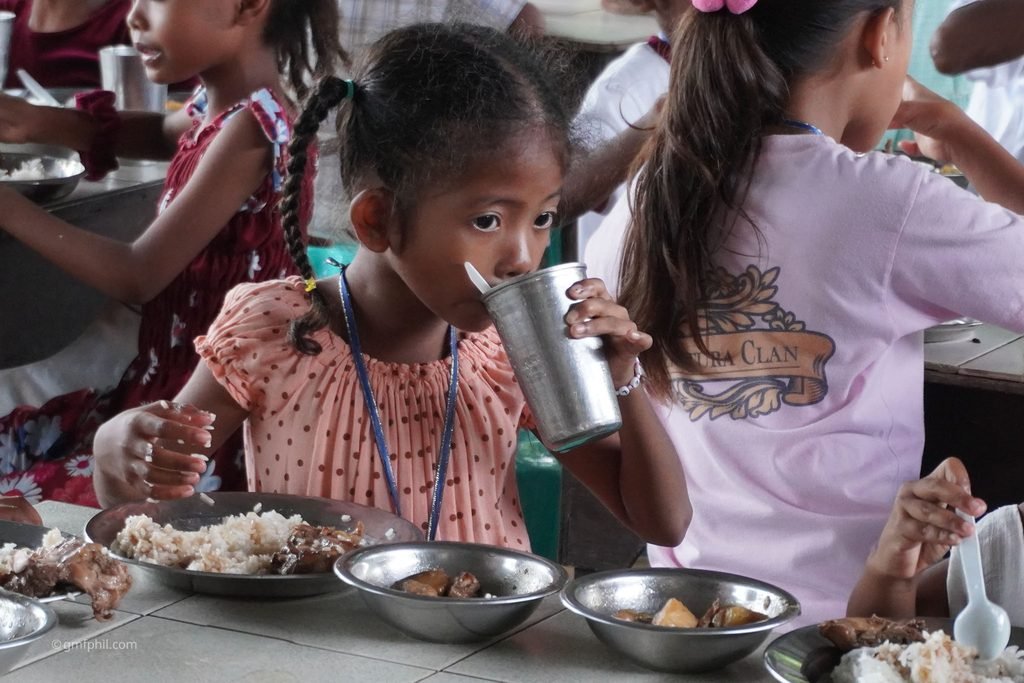 Aeta girl enjoys her meal.
