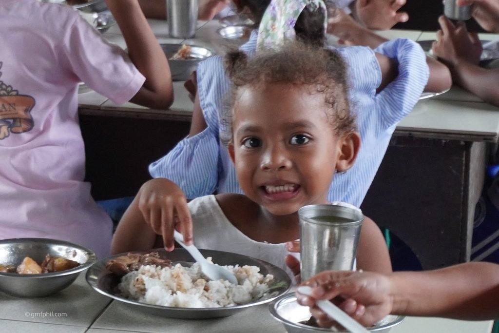 Aeta girl enjoys her meal.