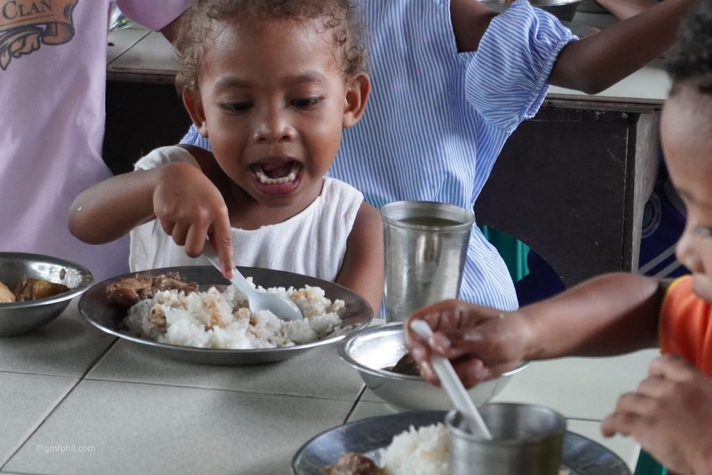 Aeta girl enjoys her meal.