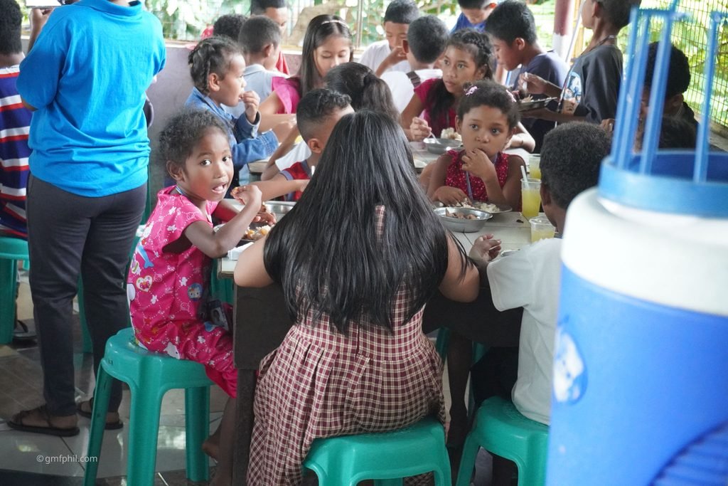 Many children enjoy meal.