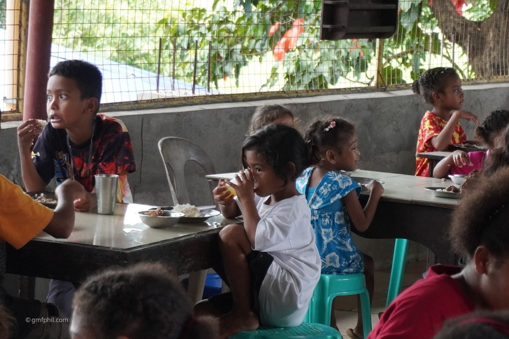 Kids eat and enjoy meal.